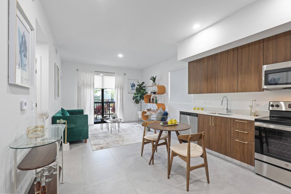Kitchen with wooden cabinets and stainless steel appliances in A2 Floor Plan at Westgate on University in Lauderhill, FL