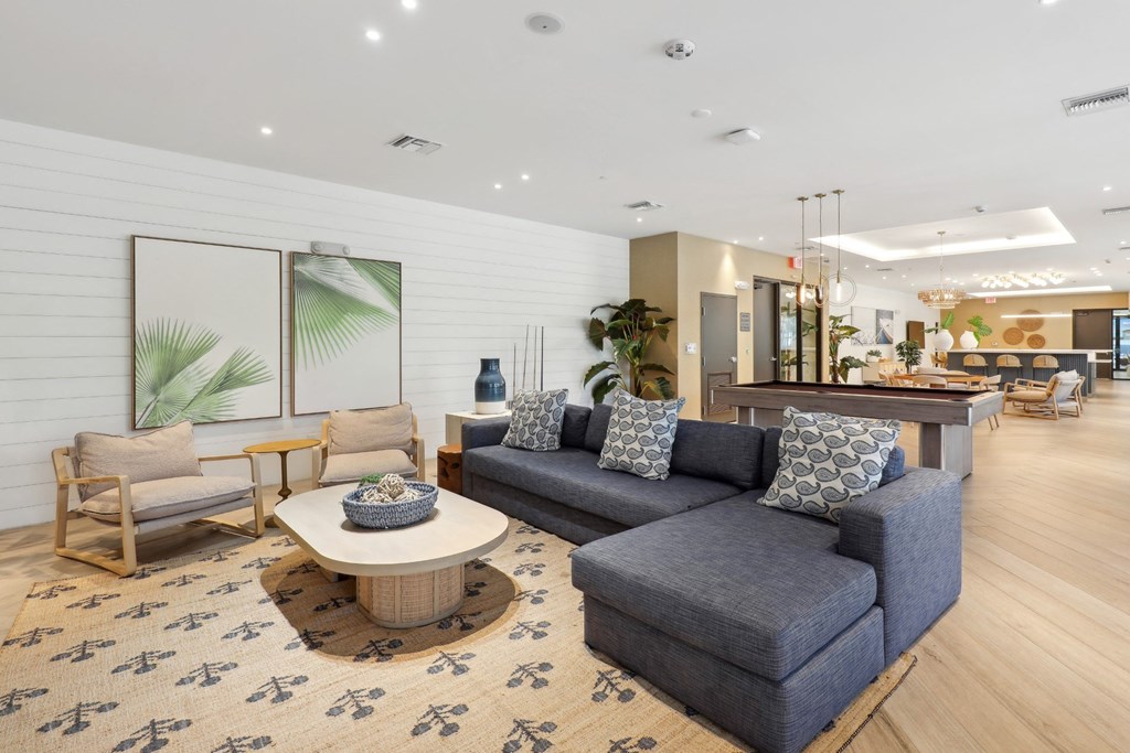 Resident Social and Gaming Lounge with L-shaped couch at Westgate on University in Lauderhill, FL