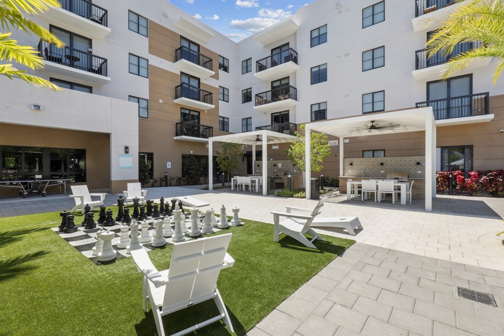 Green space and outdoor kitchen stations at Westgate on University in Lauderhill, FL