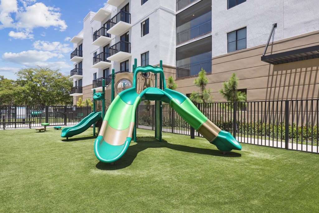 Green playground with slides at Westgate on University in Lauderhill, FL