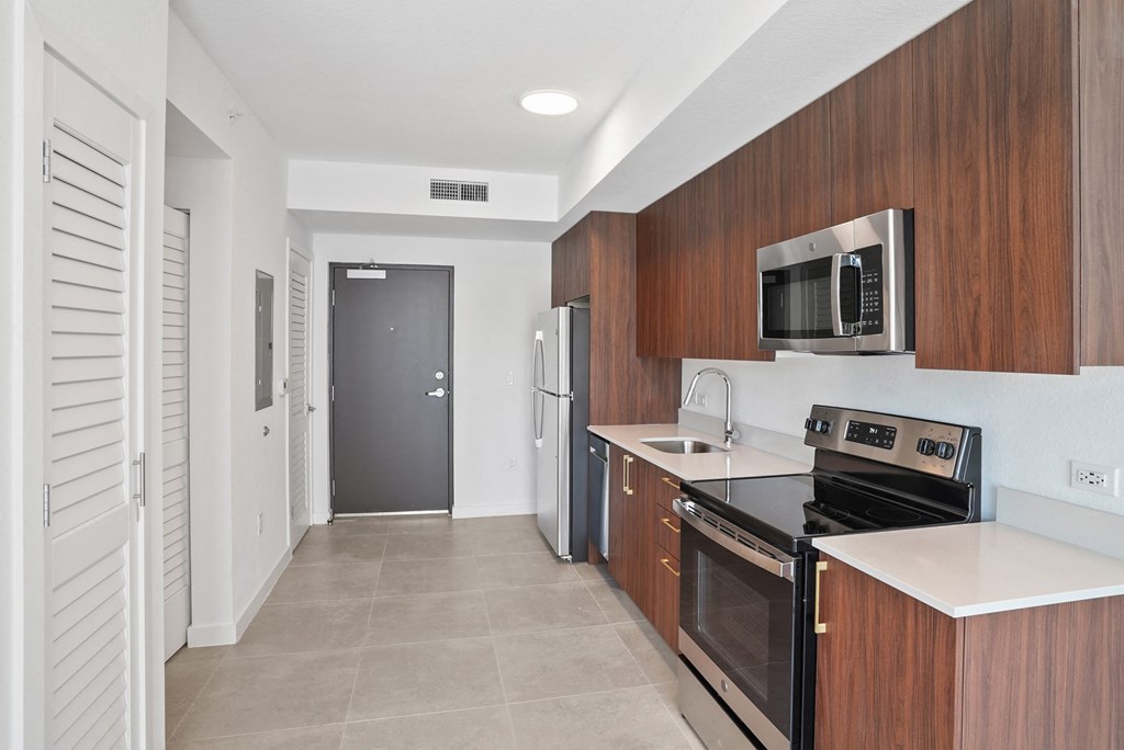 a kitchen with a stove top oven next to a refrigerator