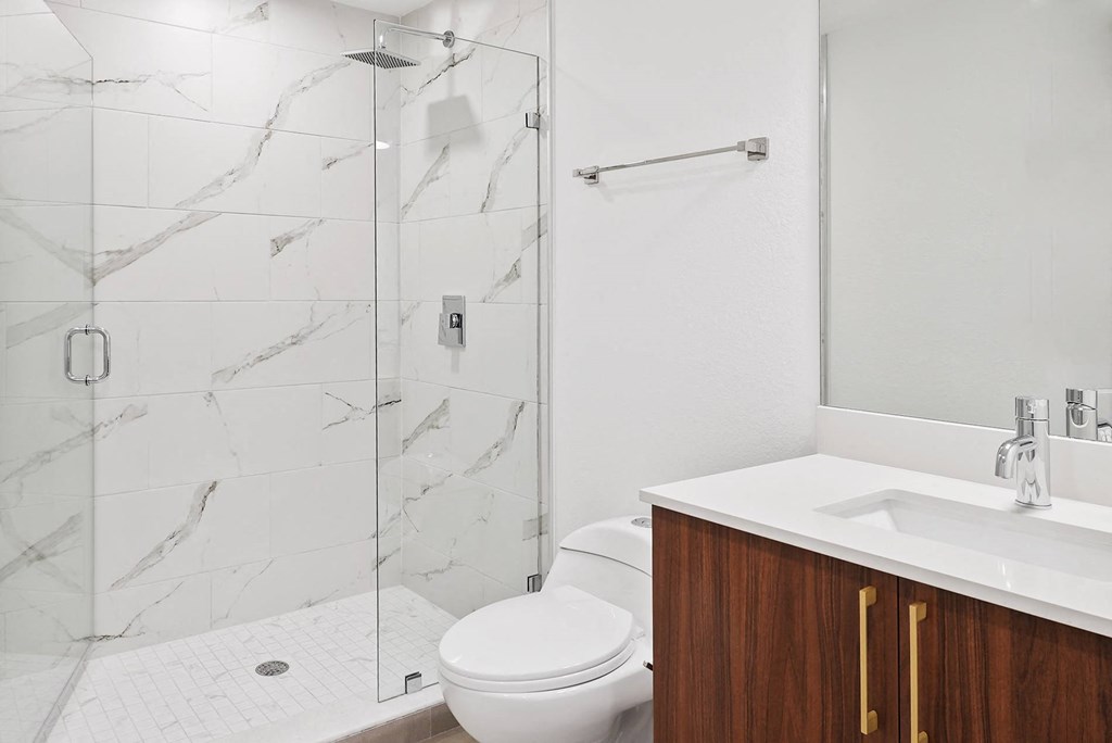 a bathroom with a toilet sink and shower