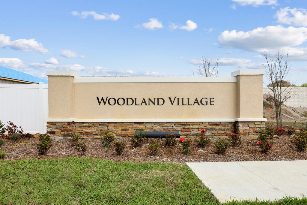 a sign with the word woodland village on it at Beacon at Woodland Village, DeLand