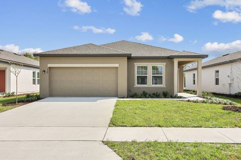 a house with a garage and a lawn at Beacon at Woodland Village, DeLand, FL
