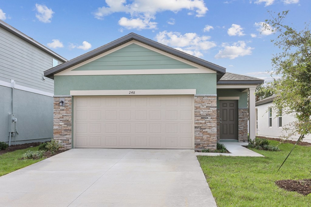 a house with a garage door at Beacon at Woodland Village, DeLand