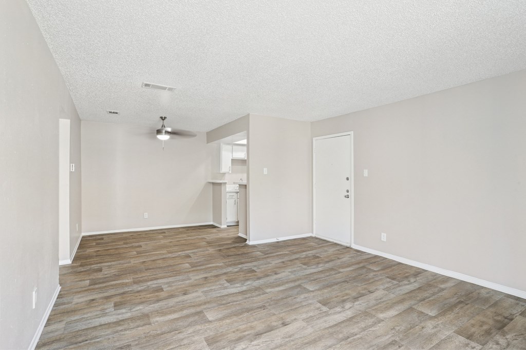 A5 living room with vinyl wooden flooring at Windridge on the Parkway apartments in Dallas, TX