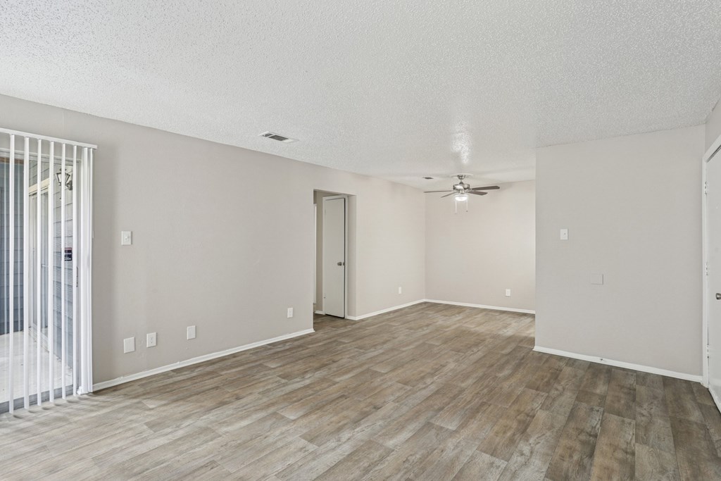 A6 living room with vinyl wood flooring and a ceiling fan Windridge on the Parkway apartments in Dallas, TX