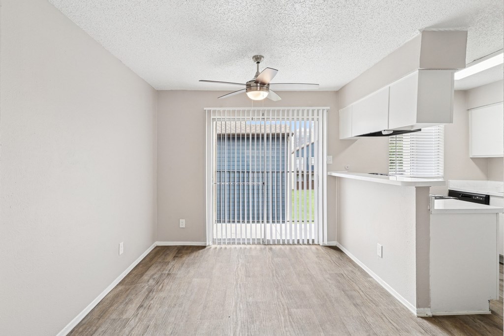 B6 dining room with a ceiling fan and wooden floor at Windridge on the Parkway in Dallas, TX