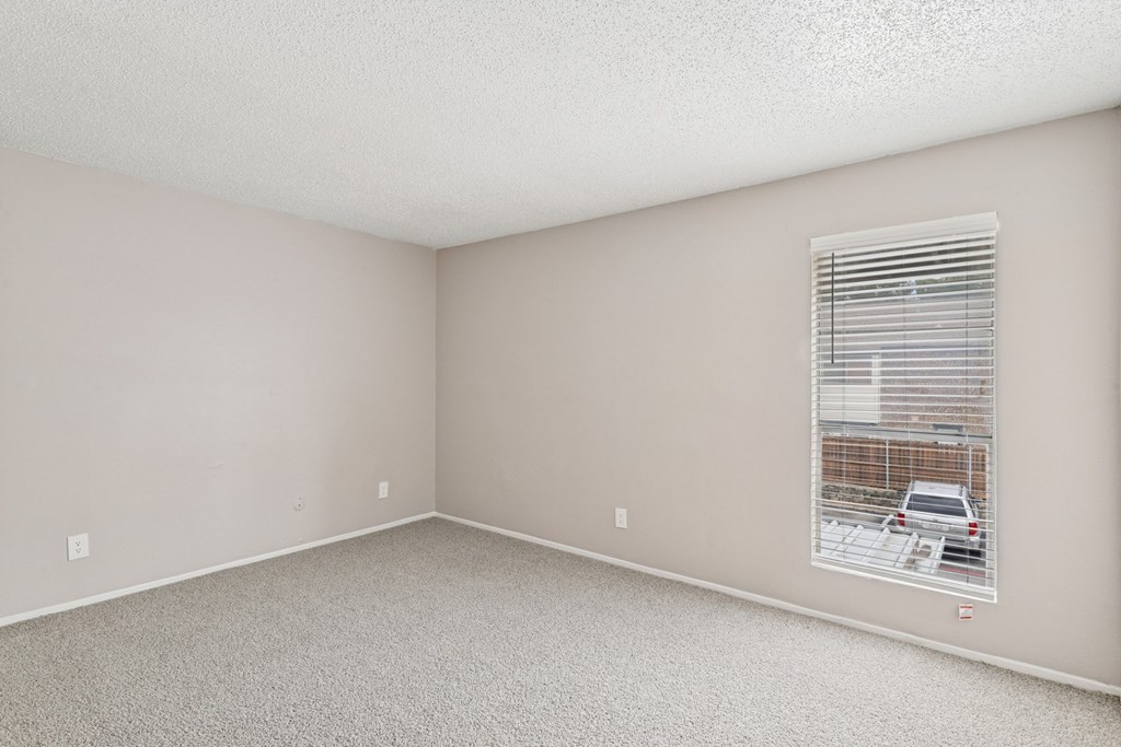 Carpeted B6 bedroom with a window at Windridge on the Parkway in Dallas, TX