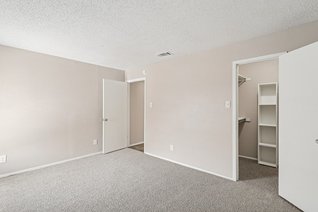 B6 bedroom with a closet, carpet, and white walls at Windridge on the Parkway in Dallas, TX