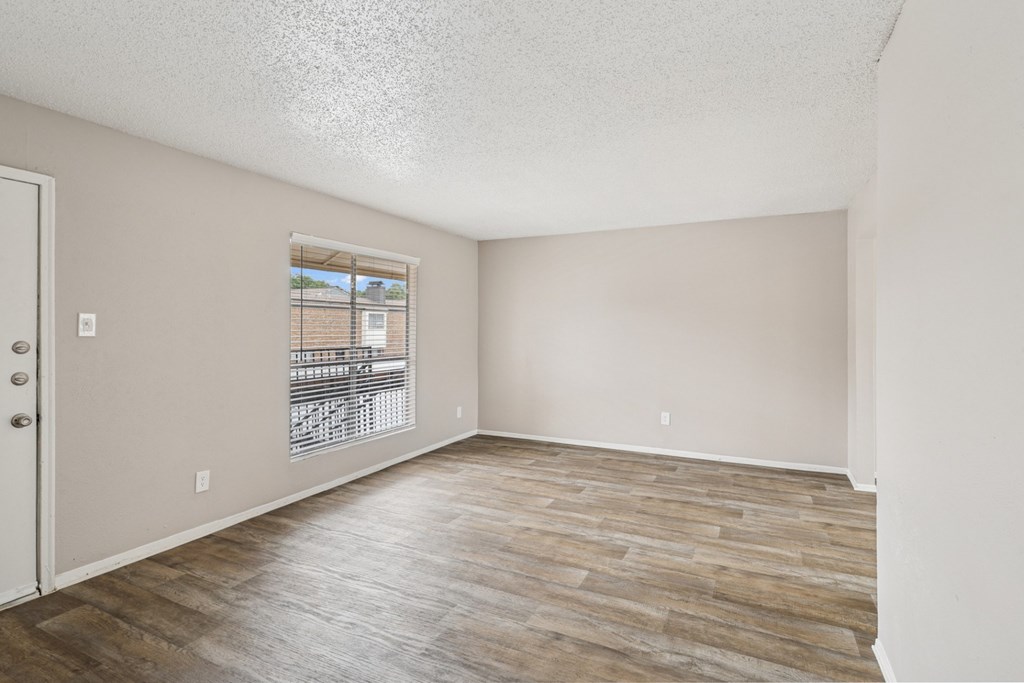B6 living room with wooden flooring and a window at Windridge on the Parkway in Dallas, TX