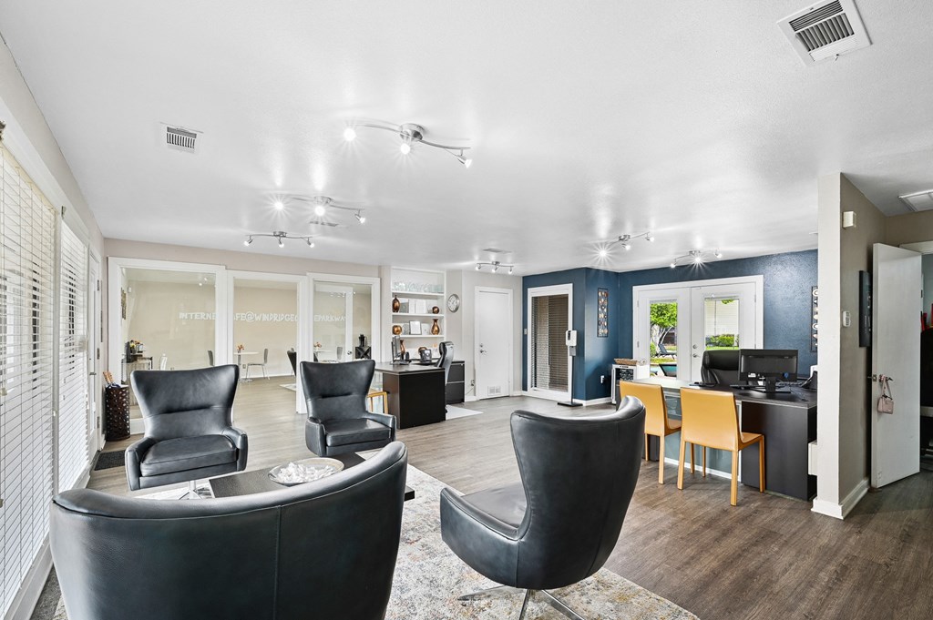 Interior of leasing office with a lot of comfortable seating at Windridge in Dallas, TX