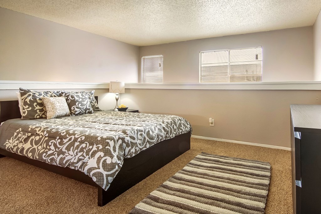 a bedroom with a large bed and a window