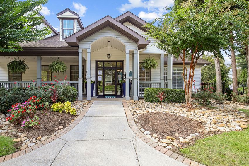 the front of a house with a walkway and landscaping