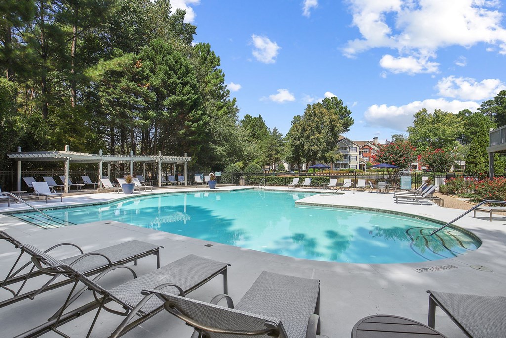 Beautiful swimming pool with poolside lounge chairs at Wellington Ridge apartments in Lawrenceville, GA