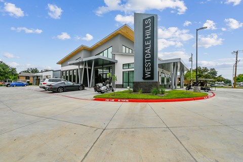 A building with a sign that says Westdale Hills in front of it.