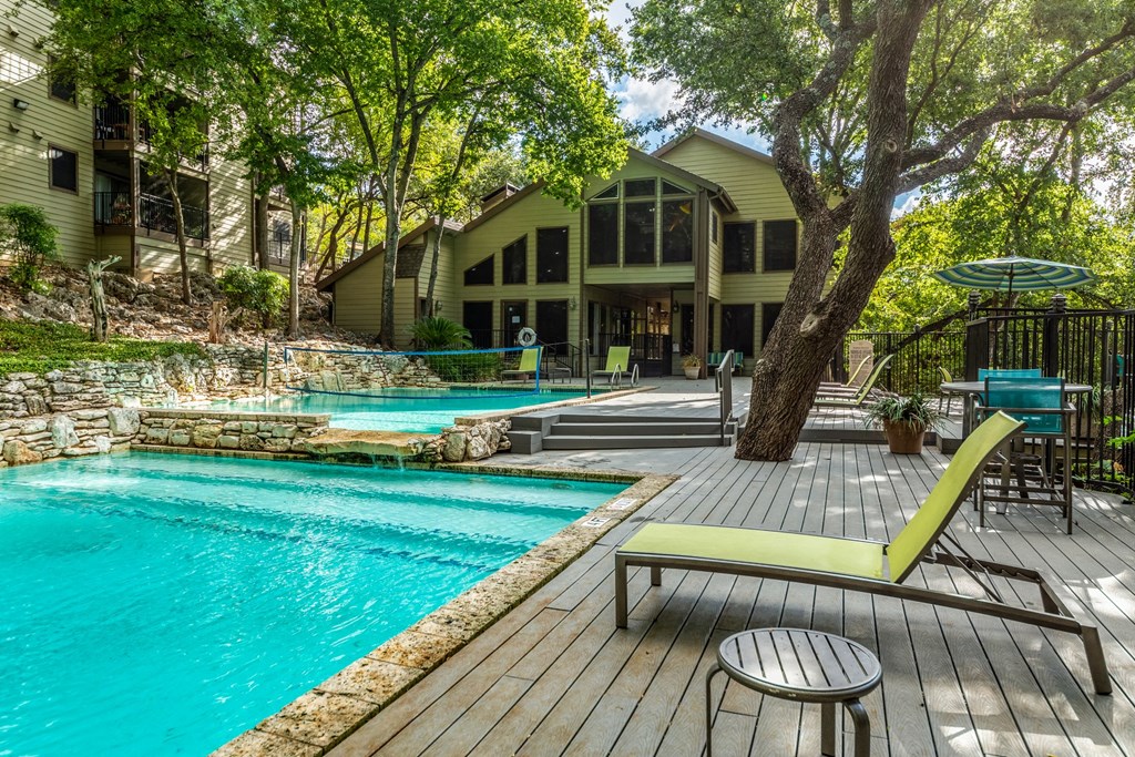 the backyard of a house with a swimming pool and patio furniture