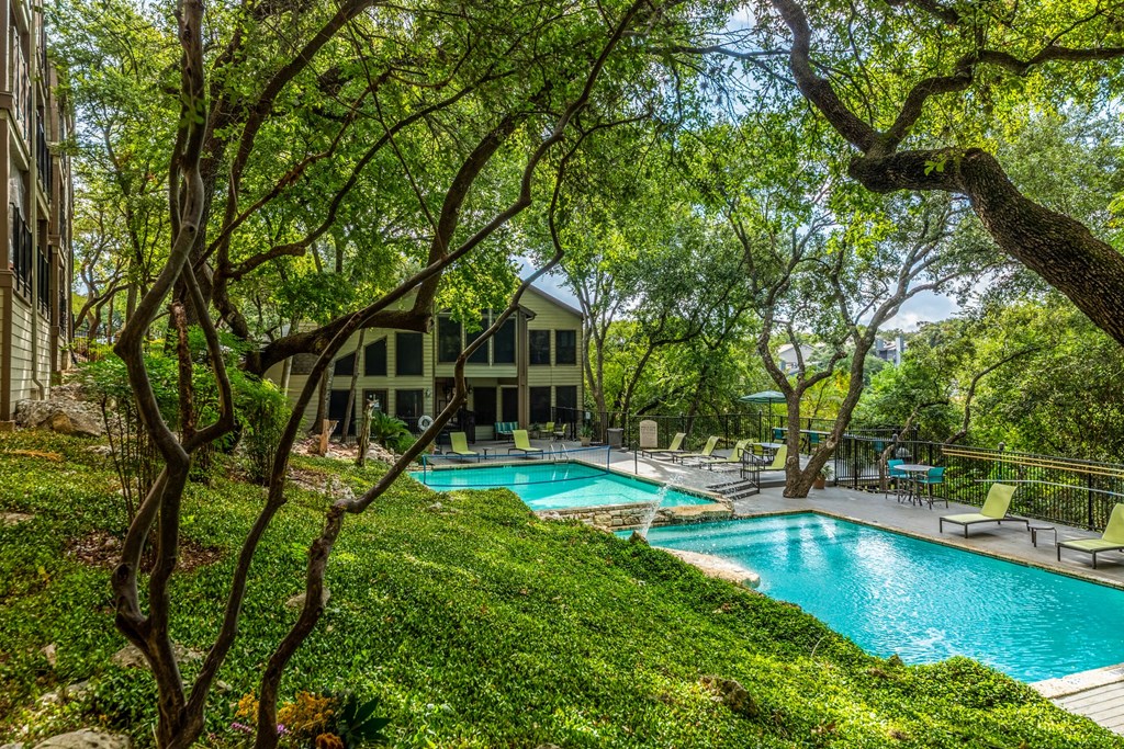 a swimming pool with a house in the background