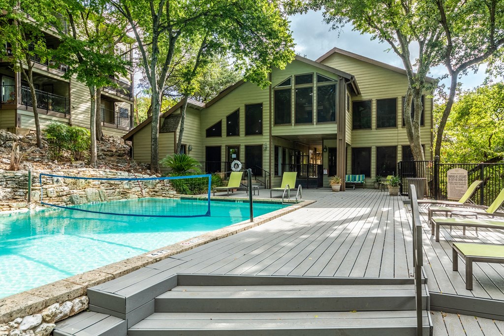 a house with a swimming pool and a deck