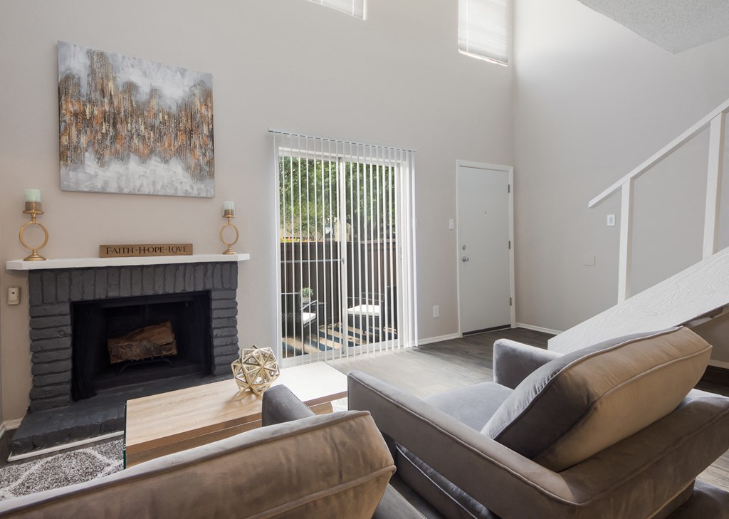 a living room with a fireplace and a sliding glass door