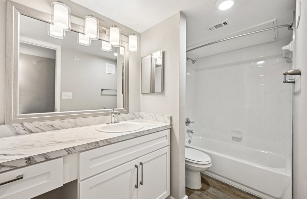 Stylish bathroom area in the D5 floor plan at Windridge On The Parkway Apartments in Dallas, TX