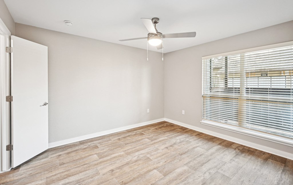 Cozy bedroom area in the D5 floor plan at Windridge On The Parkway Apartments in Dallas, TX