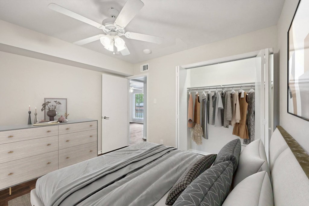 a bedroom with a bed and a closet at Woodlands of Plano in Plano, TX