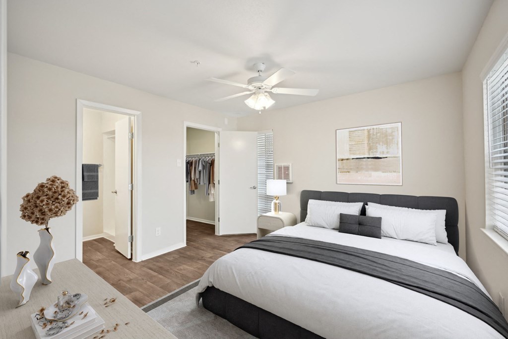 a bedroom with a large bed and a ceiling fan