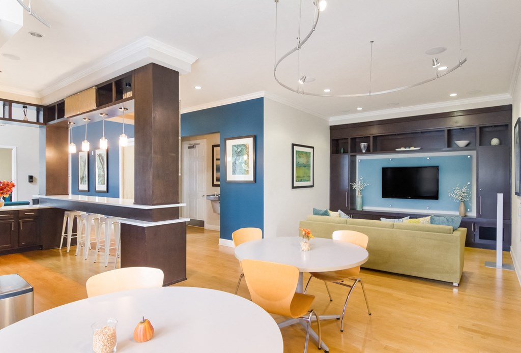 a living room and dining room with a table and chairs
