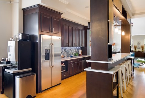a large kitchen with stainless steel appliances and a bar