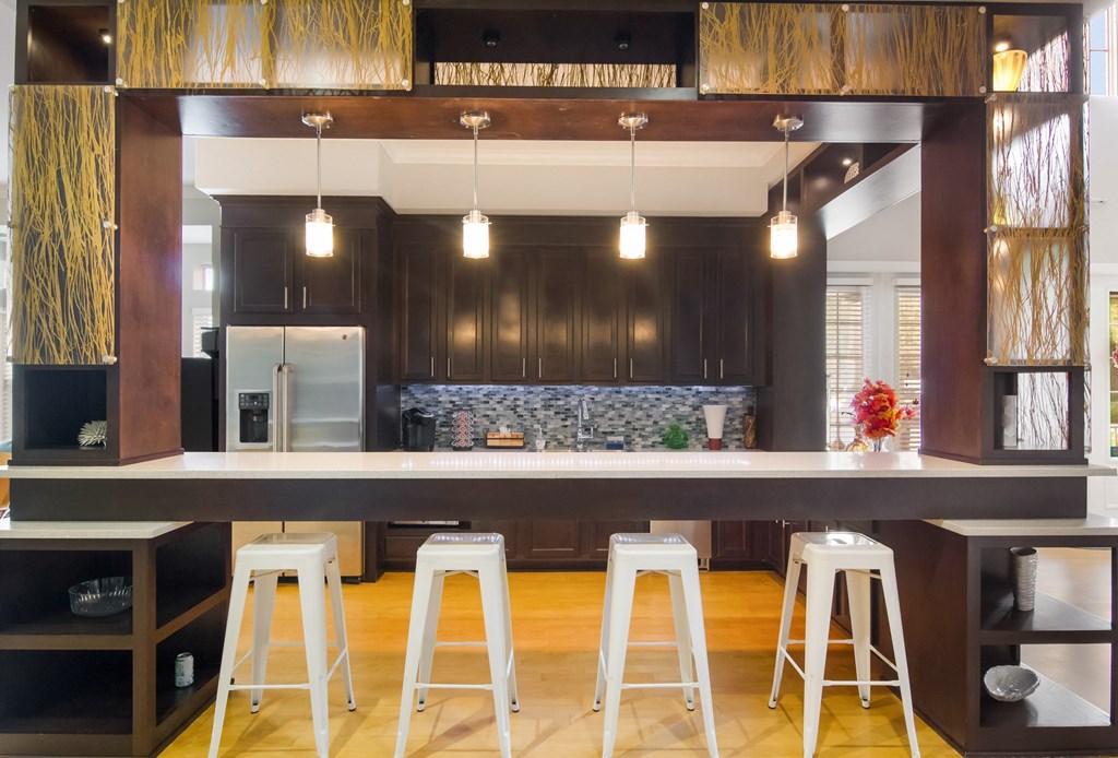a kitchen with bar stools and a large island