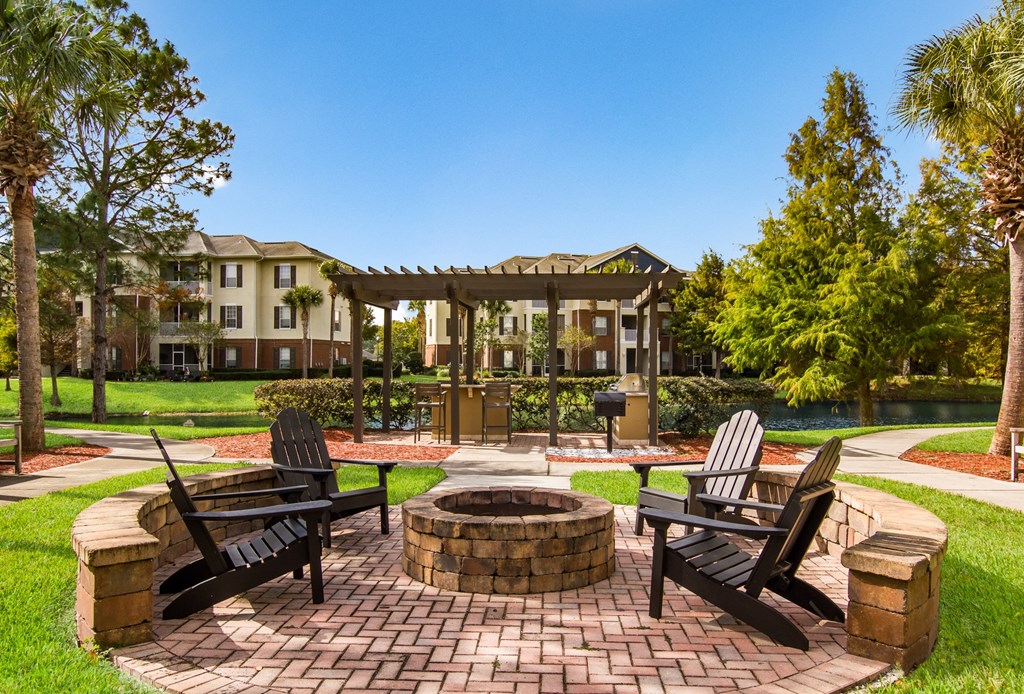 the preserve at ballantyne commons clubhouse with patio furniture and a fire pit