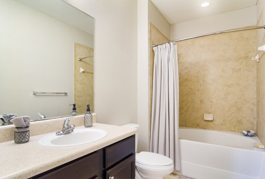 a bathroom with a sink toilet and bathtub