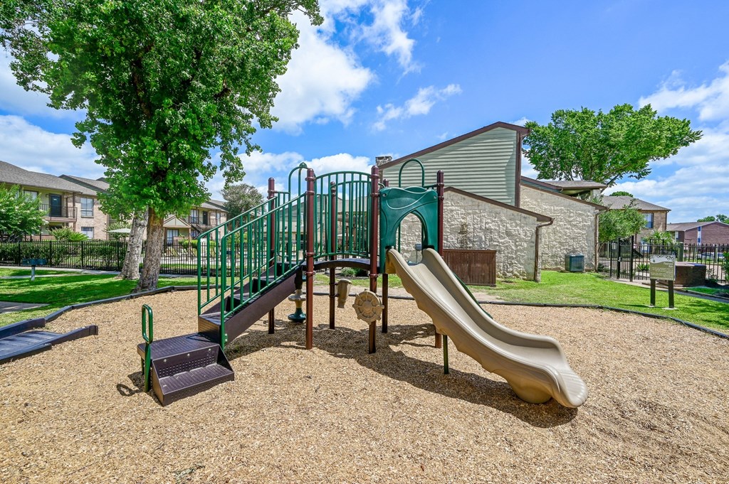Our fun playground with a slide at Bear Creek Crossing in Houston, TX