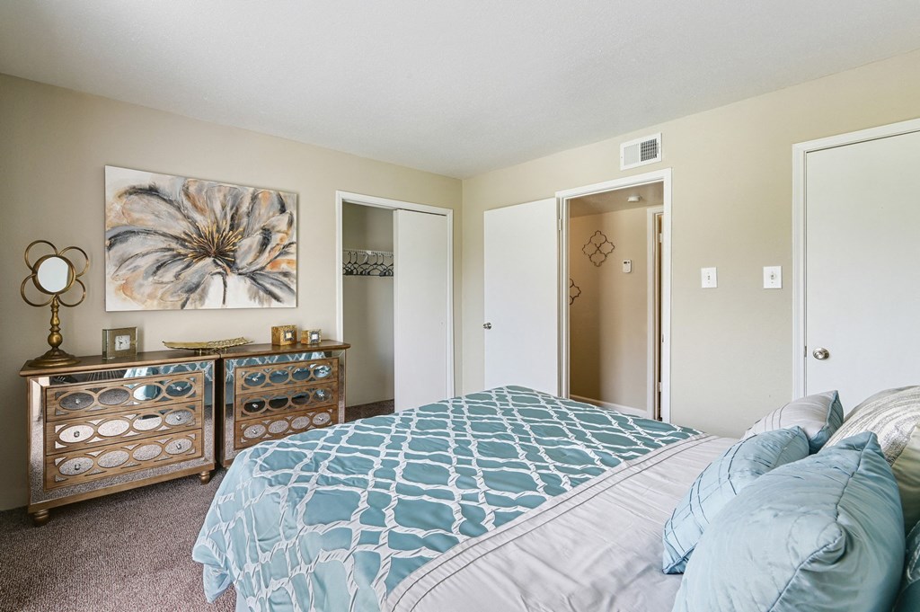 a bedroom with a large bed and a dresser
