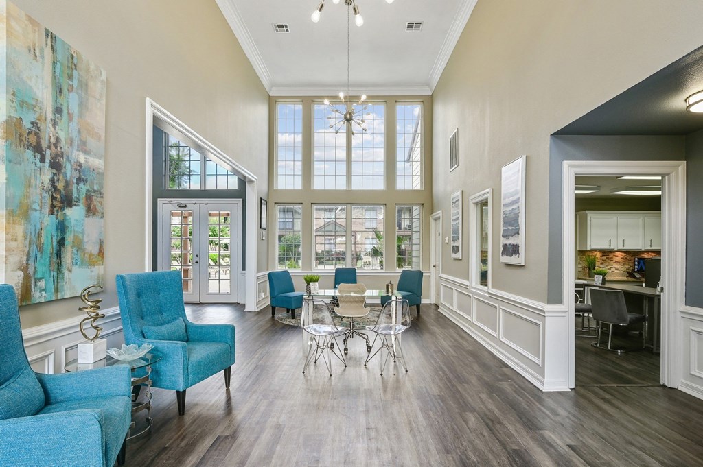 a living room with blue furniture and a large window