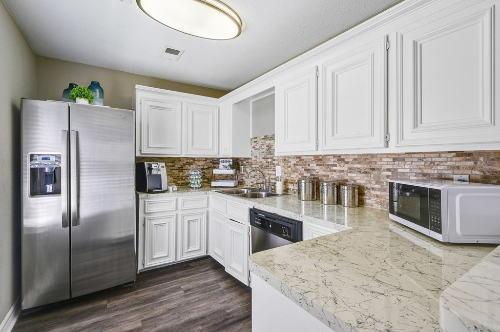 Clubhouse kitchen with white cabinets and stainless steel appliances