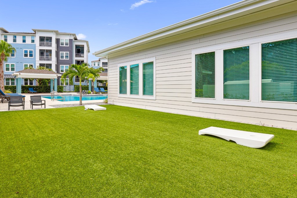 Corn hole boards by the pool at Dunedin Commons apartments in Dunedin, FL