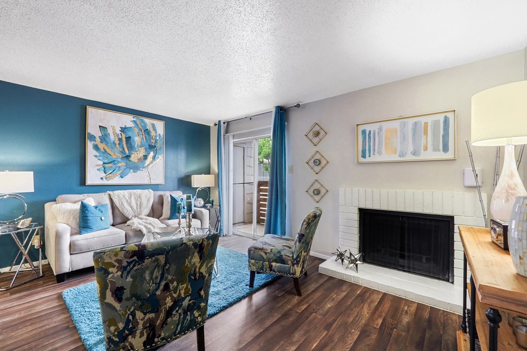 a living room with a couch chair and fireplace