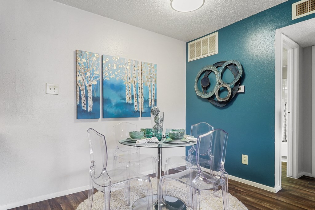 a dining room with a table and chairs