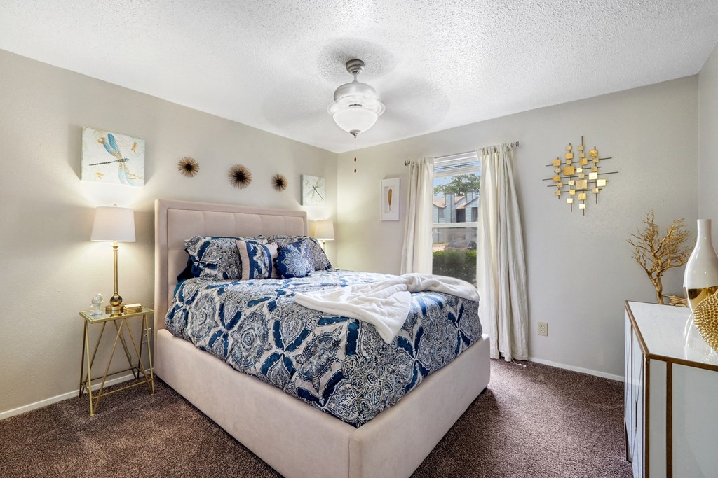 a bedroom with a bed and a window