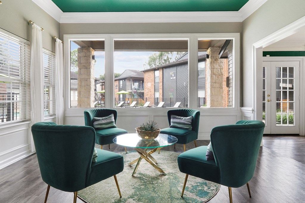 a living room filled with furniture and a large window