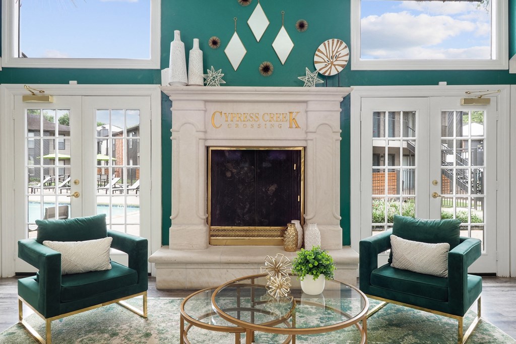 a living room with green walls and a fireplace