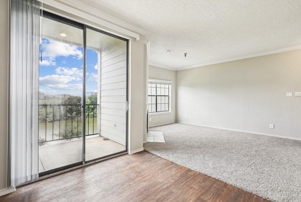 A2 floor plan dining and living room with sliding glass doors to a balcony at Jefferson Creek Apartments in Irving, TX.