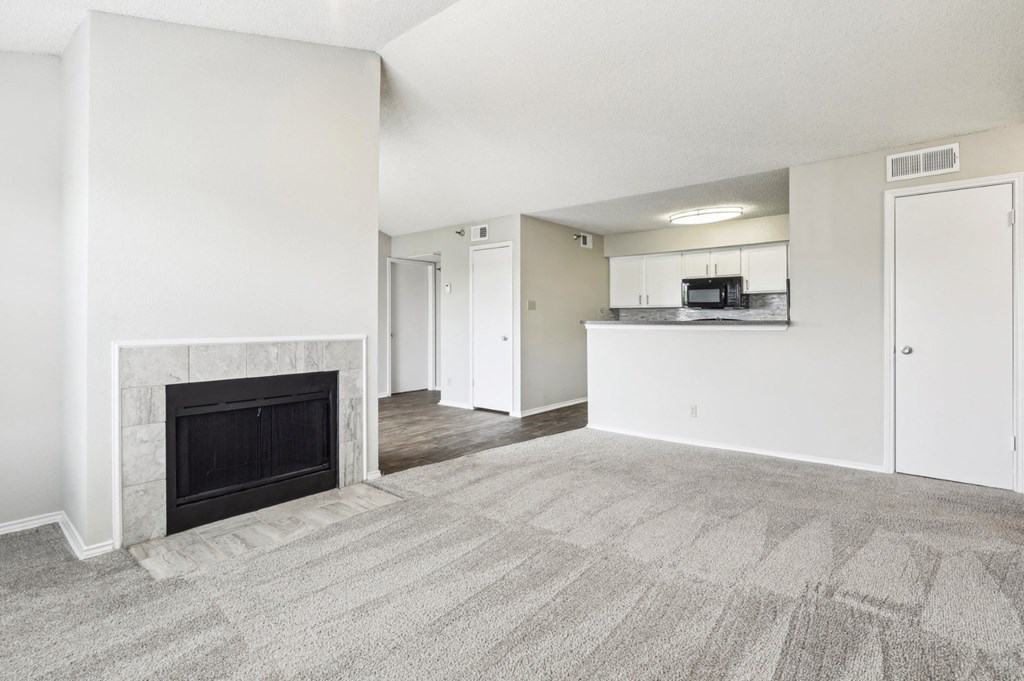 A3 floor plan living room with a fireplace and a kitchen at Jefferson Creek Apartments in Irving, TX.