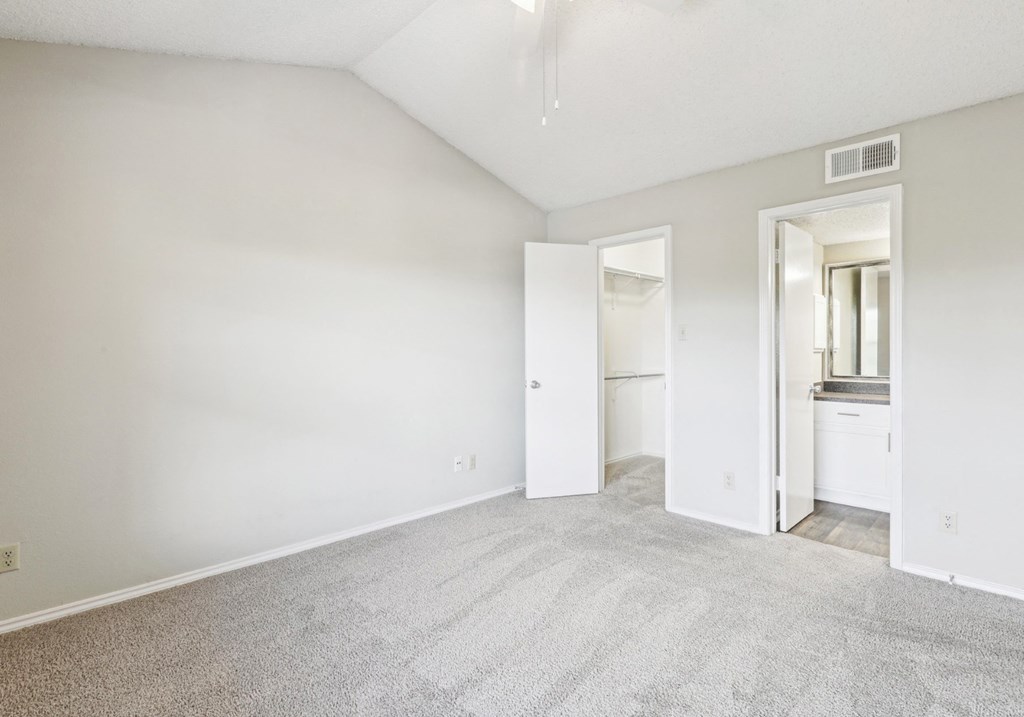 A3 floor plan bedroom with vaulted ceiling and private bathroom entrance at Jefferson Creek Apartments in Irving, TX.