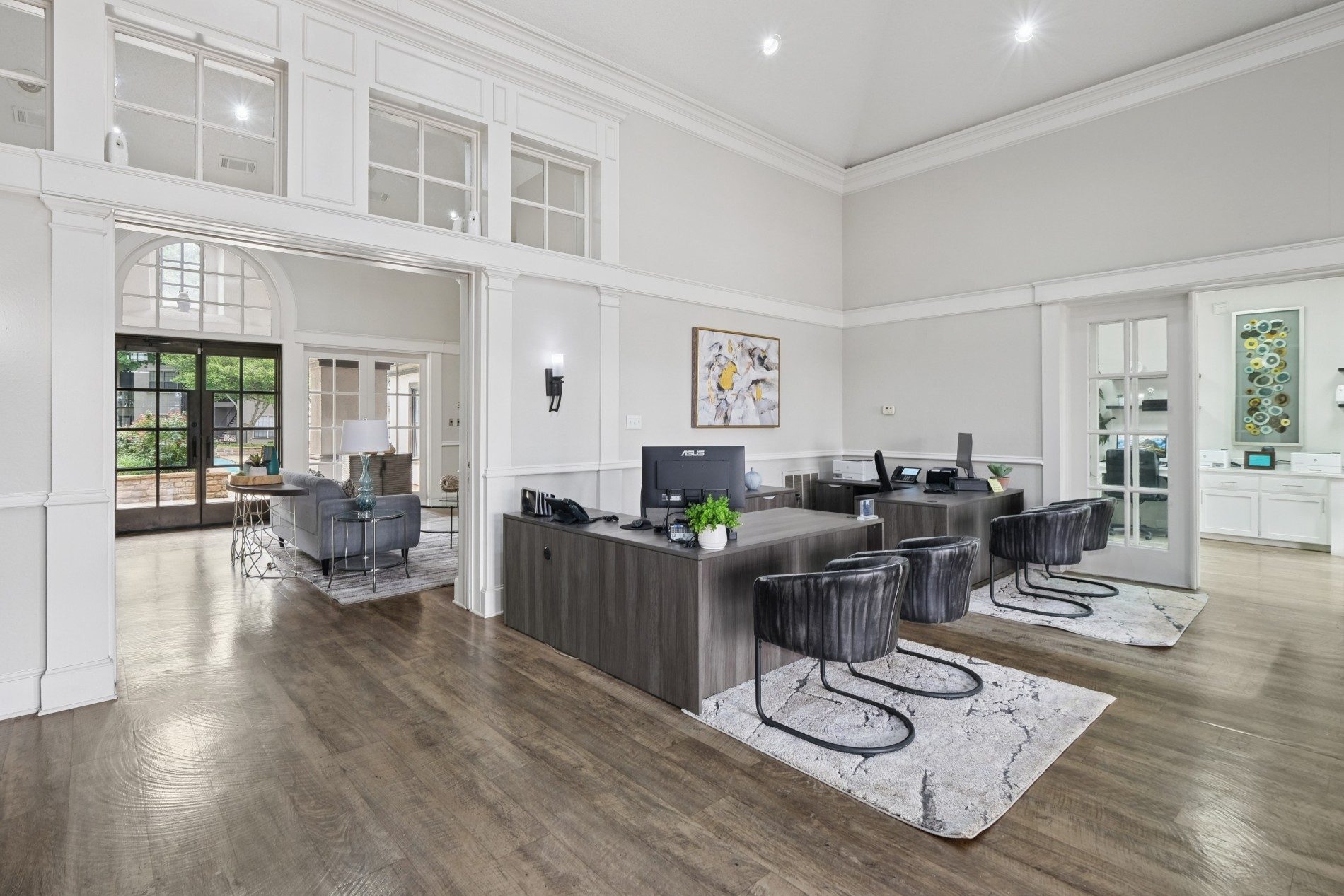 A modern living room with a grey sofa set and a wooden floor.
