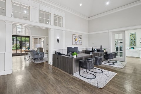 Leasing office with desks and a lounge area at Jefferson Place Apartments in Irving, TX
