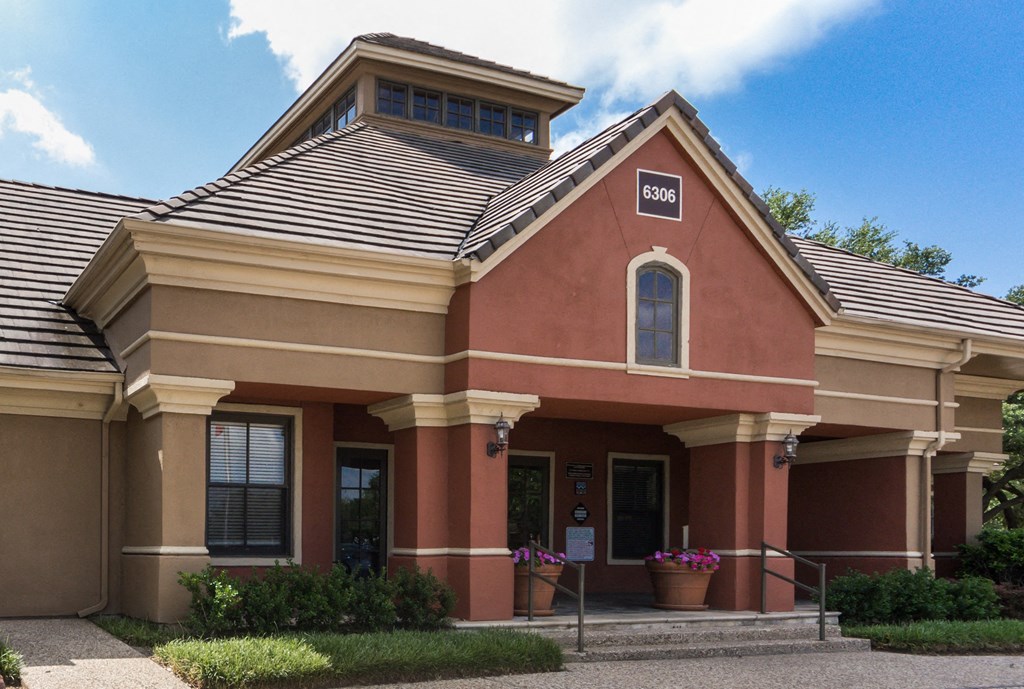 a red building with tan trim and a brown roof