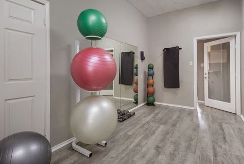 a room with a large white ball and a green ball on top of a white ball